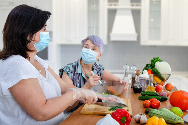 Homemaker in the kitchen with a senior woman